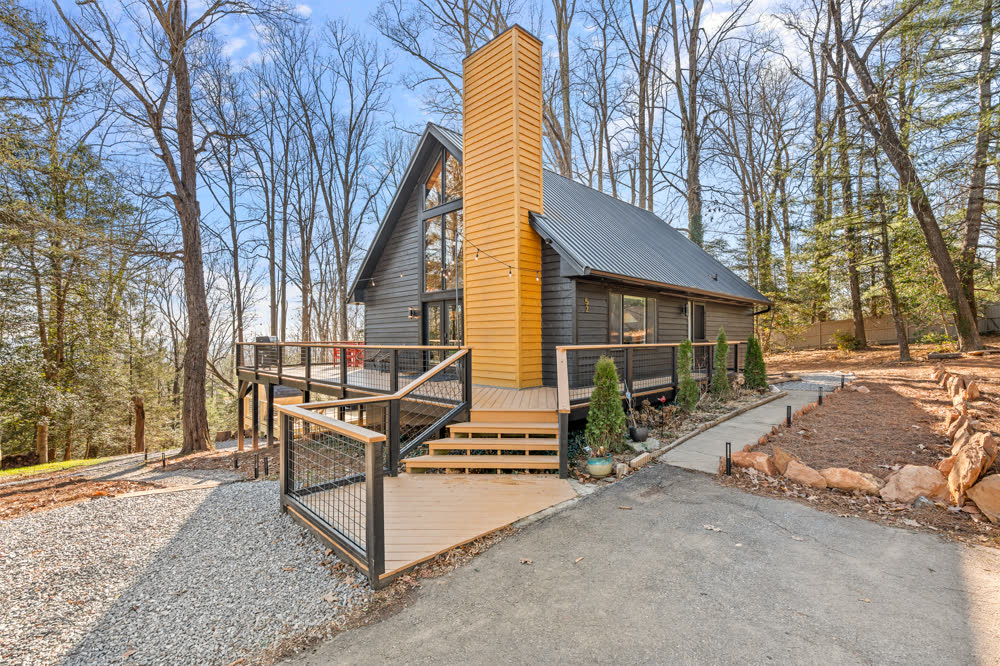 The Ridgetop A-Frame cabin with tall chimney in the woods, Asheville NC