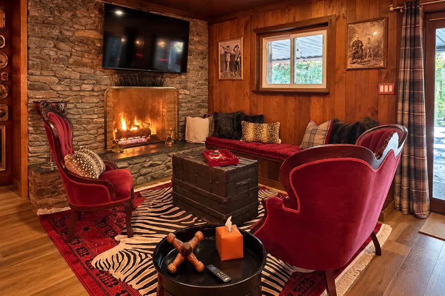 Red Stag Lounge with stone fireplace and red velvet chairs
