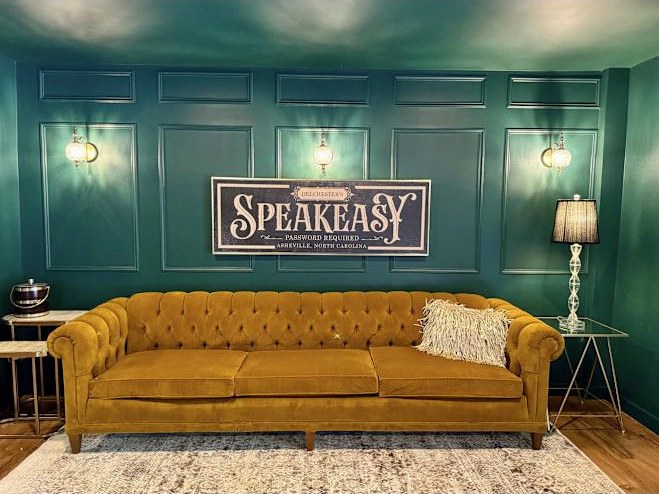 Speakeasy lounge with a mustard velvet sofa at Biltmore Forest Retreat, Asheville NC